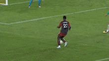 a soccer game is being played on a field with a continental advertisement in the background
