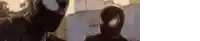 a blurry picture of a man in a spiderman suit standing next to another man .