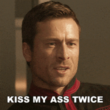 a close up of a man 's face with the words kiss my ass twice below him