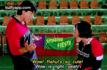 a man and a woman are standing next to each other in a stadium .