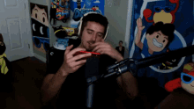 a man wearing headphones is looking at his phone