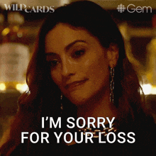 a woman says i 'm sorry for your loss while wearing earrings