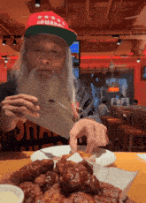 a man with a beard wearing a red hat that says ' donald trump '