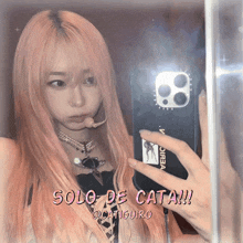 a girl with pink hair is taking a picture of herself in a mirror