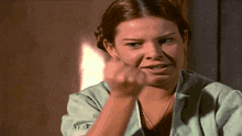 a woman in a green dress is pointing at something