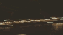 a blurry picture of a person standing in the water at night .