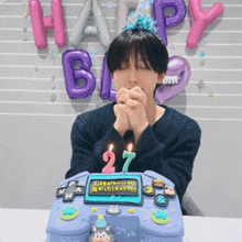 a man with his eyes closed is sitting in front of a birthday cake that says 27th