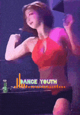 a woman in a red top is dancing in front of a dance youth sign