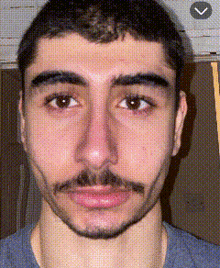 a close up of a man 's face with an arrow pointing to the left