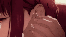 a close up of a person touching another person 's ear with their finger