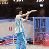 a person standing in front of a sign that says to we expend fight effort together with togo