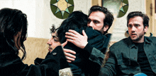 a man and a woman hugging each other in a room