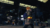 a person standing in a dark room with a yellow light coming out of their back