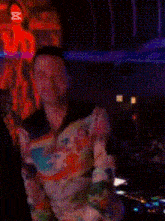 a blurred image of a woman holding a rainbow colored item