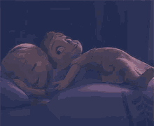 a cartoon character is laying on a bed with purple sheets