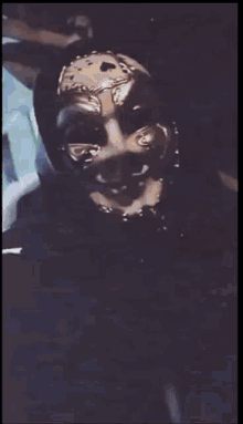 a person with a mask on their face is standing in a room