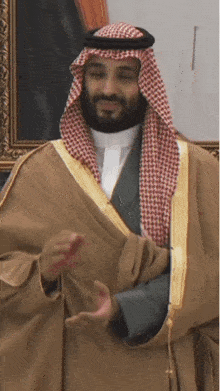 a man with a beard is wearing a traditional arabian costume