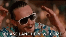 a man wearing sunglasses and a colorful shirt is smiling and says `` chase lane here we come '' .