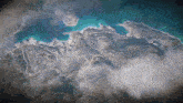 an aerial view of a large body of water with mountains in the background
