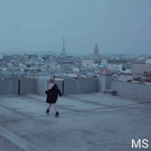 a woman is rollerblading on a rooftop with the eiffel tower in the background
