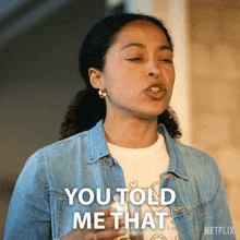 a woman in a denim jacket is holding a glass and saying " you told me that "