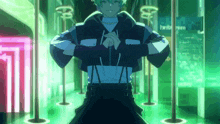 a man in a black and white jacket stands in a dark room