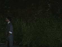 a man in a suit and tie is standing next to a woman