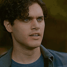 a close up of a man 's face with his mouth open