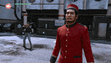 a man in a red uniform stands in front of a building in a video game