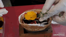 a person wearing white gloves is putting a flower on top of a dessert made in animatica