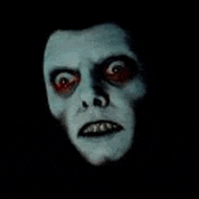 a close up of a person 's face with glowing eyes and a smile