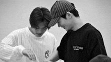 a black and white photo of two men one wearing a shirt that says psychic fever