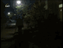 a sbs channel shows a man walking down a dark street