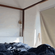 a bed with a canopy and a guitar on the wall