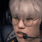 a close up of a person wearing glasses and a headset with a microphone