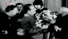 a black and white photo of a man holding a little girl with the letter h above them