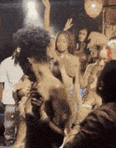 a group of people are dancing at a party and one of them is wearing a watch