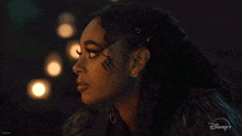 a close up of a woman 's face with a disney+ logo in the corner