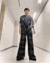 a person standing in a hallway with a sign on the wall that says ' a ' on it