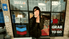 a man standing in front of a chevron store
