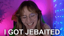 a woman wearing glasses is smiling and says i got jebaited .