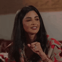 a woman is making a funny face with her eyes closed and her mouth open .