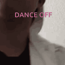 a close up of a man 's face with the words dance off written in pink