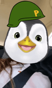 a penguin is wearing a green hat with the letter p on it