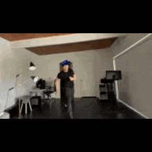 a man wearing a blue hat is running through a room