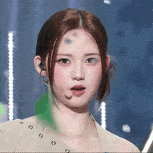 a close up of a woman wearing a microphone and earrings
