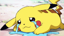 a pikachu is crying while laying on the ground with tears coming out of its eyes .