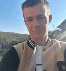 a man wearing a varsity jacket with the letter d on it
