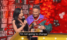 a man and a woman standing in front of a sign that says jersey shore