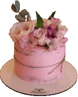 a pink cake with flowers on top of it sits on a white plate that says martin 's